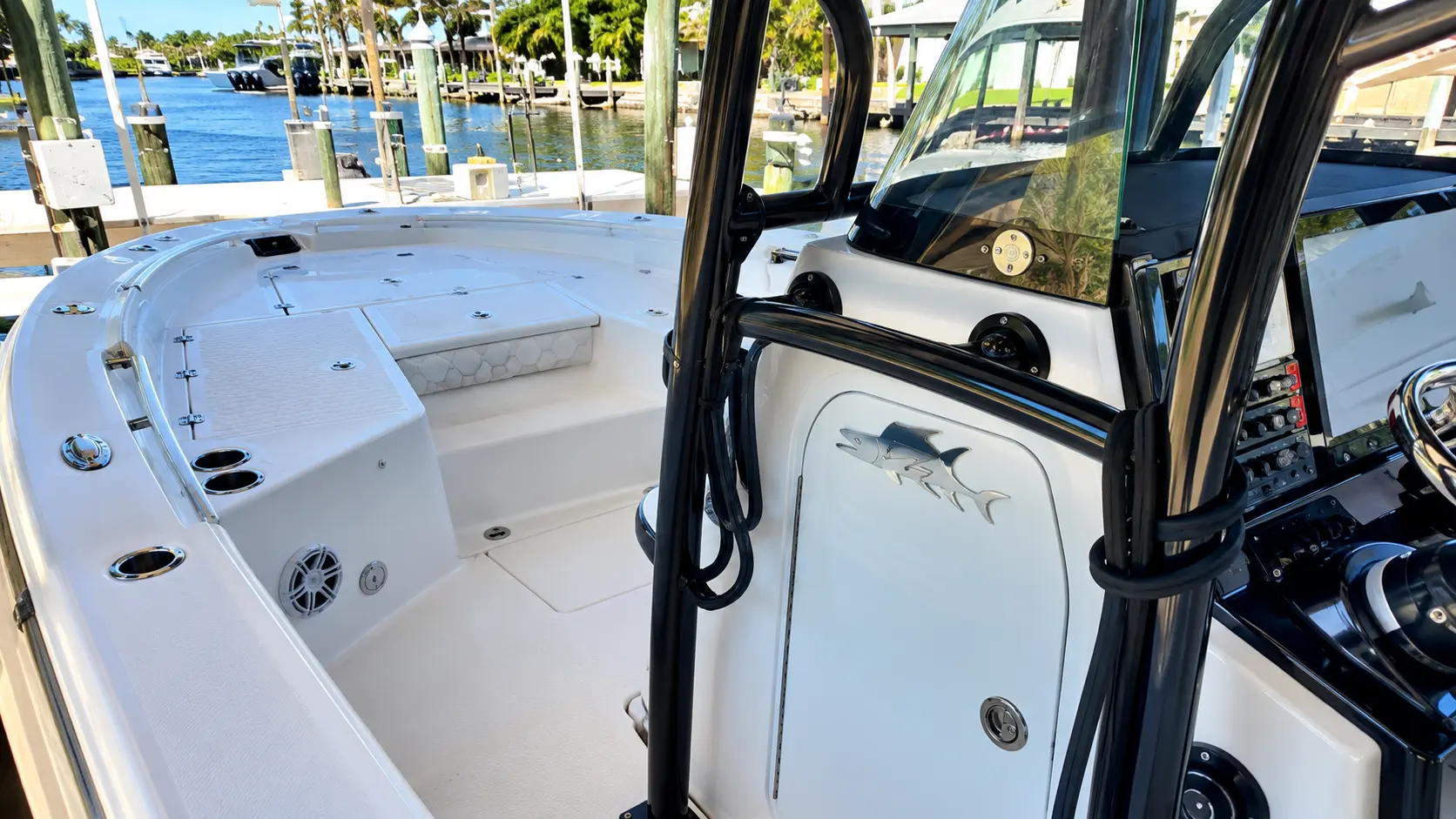 Interior view of white fishing boat docked at marina with open cabin door